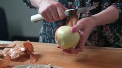 Woman peeling onion Stock Footage