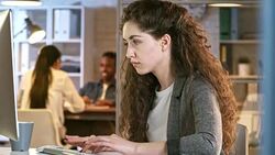 Young Lady Working on Computer Late in Office Stock Footage