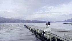 Asian tourist woman taking picture at scenic view of Lake Kawaguchi Stock Footage