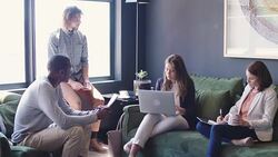 Professionals discussing in office lobby Stock Footage
