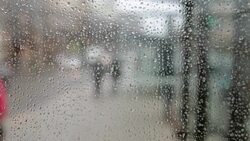 Rain drops on a window bus stop Stock Footage