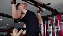 Young Asian muscular man exercising doing pull ups on bar in the gym, lifestyle sport and bodybuilding concept Stock Footage