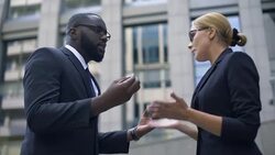 Businesswoman and male colleague quarreling, gender equality, no discrimination Stock Footage