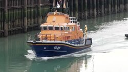 RNLI lifeboat towing migrant dinghy into harbour News Clip