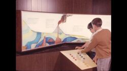 1970s: Boys point at key and look up at cross-section of ground Stock Footage