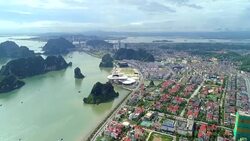 4k Aerial view over city and park with Bai Tho karst mountain Ha long bay. Halong City. Stock Footage