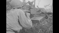 South Korean soldiers fire machine guns; soldier paints salve on wounded arm in the Korean War News Clip