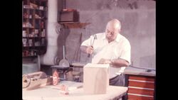 1970s: Man saws wood on table saw Stock Footage