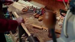 Tools are used to round and smooth and long piece of wood in a workshop. Stock Footage