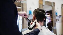 man and stylist doing haircut at barber shop Stock Footage