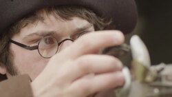 Revolutionary war soldier pulling cock of musket Stock Footage