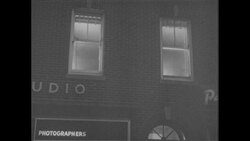 1960s: Man lights cigarette for woman outside building, Group of men sit around table, talk, smoke cigarettes Stock Footage