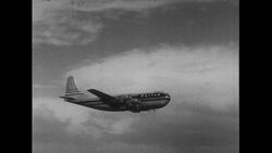 Hawaii, 1952: A plane lands in Hawaii after which visitors are greeted with a warm hula dance Stock Footage