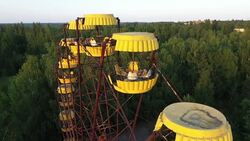 Drone aerial shots of an abandoned ferris wheel in Pripyat News Clip