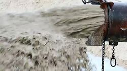 Close Up: Sand Pouring Out of Pipe Stock Footage