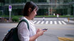 Women requesting taxi from a smart phone Stock Footage