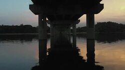 Zoom in at the sunrise under the bridge Stock Footage