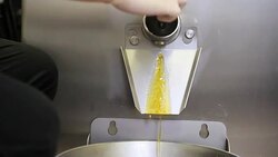 hands pastry chef prepares jam with industrial mixer kettle machine, pour into the bowl and place on industrial kitchen steel worktop Stock Footage