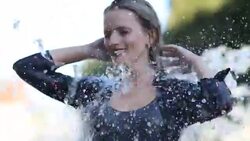 Woman refreshes under a fountain Stock Footage