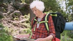 Senior Woman Looking at Map in Forest Stock Footage