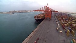 Timelapse of a loaded cargo ship docked in a port in Oman Stock Footage