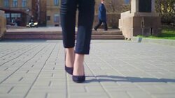 Close-up view of female feet walking through the downtown. Businesswoman wearing shoes with heels Stock Footage