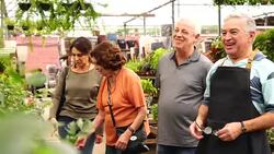 Family shop for plants with Salesman at Flower Market Stock Footage