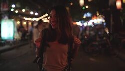 Slow motion - Young Asian traveling women backpacker drinking alcohol or beer and dancing in urban street night party at The Khao San Road in Bangkok, Thailand. Traveler and tourist concept. Stock Footage