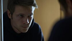 Aggressive criminal putting on balaclava in front of mirror before robbery Stock Footage