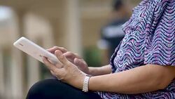 Asian Senior Woman Using Digital Tablet  in Public Park Stock Footage