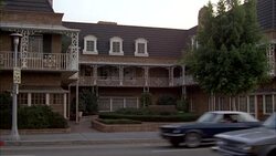 ZOOM IN ON SECOND STORY WINDOW OF LAW OFFICE BUILDING. NEW ORLEANS-STYLE WITH MANSARD ROOF AND SIGN IN FRONT THAT READS 'LAW OFFICES'. CARS DRIVING ON STREET. BUILDING IS LOCATED ON GREEN STREET IN PASADENA. ATTORNEY OFFICES. BRICK BUILDINGS. MATCHING SHO Stock Footage