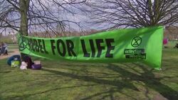 Climate change banners and protesters meeting in Hyde Park News Clip