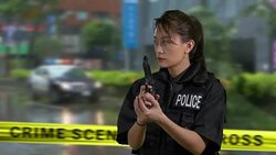 Asian American Woman Police Officer at Crime Scene Holding Gun and Looking Around Stock Footage