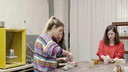 Instructor assisting student in making pottery Stock Footage