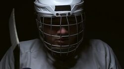 Ice Hockey player in the mask, one Lighting in dark room. Stock Footage