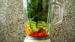 Cocktail from carrots, a stalk of a apium and spinacia.	Process of preparation of cocktail. Stock Footage