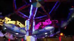 Colorful spinning wheel in amusement park at night Stock Footage