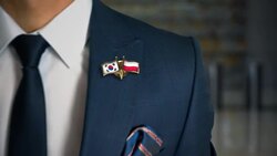 Businessman Walking Towards Camera With Friend Country Flags Pin South Korea - Poland Stock Footage