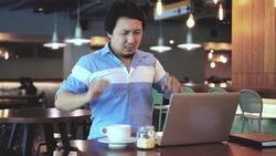 4k footage scene of Asian businessman in casual suit working and suffering with arm stiffness in front of laptop at co-working space, Business health and office syndrome concept Stock Footage
