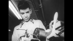 United States, 1950s: Low angle view of boy using shop equipment Stock Footage