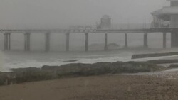 Stormy sea crashing onto snow covered shore News Clip