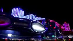 Colorful spinning wheel in amusement park at night Stock Footage