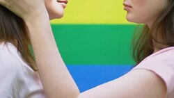 Beautiful female touching same-sex partner and kissing her with all love, lgbt Stock Footage