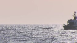 A Wide shot of a boat crashing against the waves near Atlanterra Beach News Clip