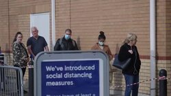 UK: Shoppers socially distancing outside Tesco supermarket in Osterley. News Clip