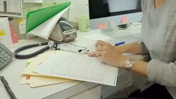 Female doctor reviewing medical chart in doctors office Stock Footage