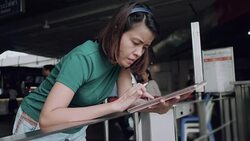 Designer drawing a sketch on tablet using stylus at city Stock Footage