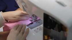 The girl sews on the sewing machine Stock Footage