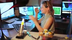 The Girl Communicates on the Headset with the Clients in the Home Laboratory. Slow Motion Stock Footage
