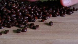 Close up of coffee beans shooting over wooden background. Stock Footage